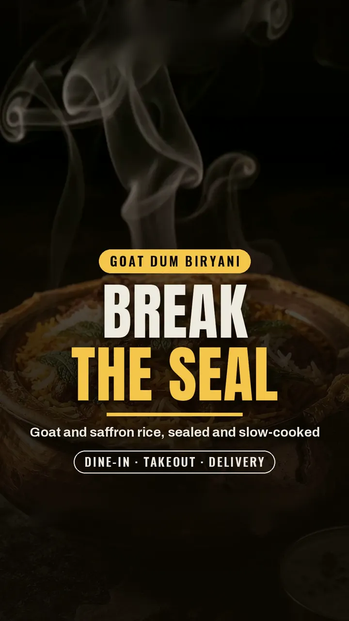 Goat dum biryani: the dough seal is broken and steam rises from goat and saffron rice.
